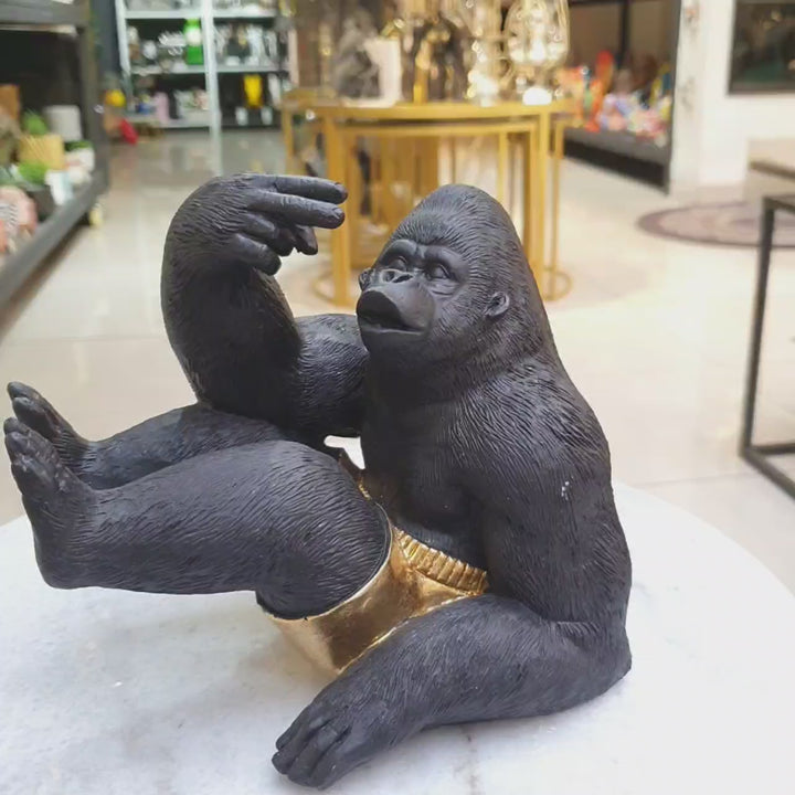 Gorila sentado con short dorado