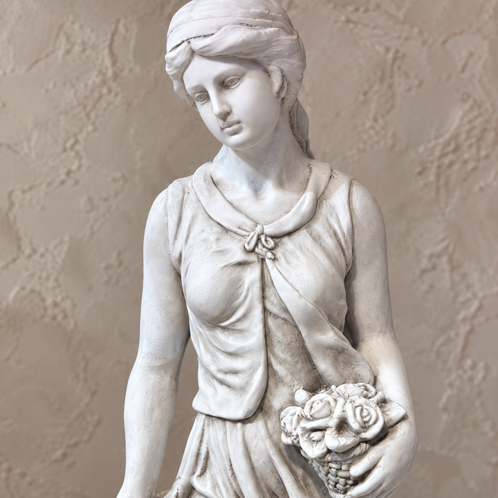 Detalle del rostro, rosas y acabado blanco envejecido de la escultura